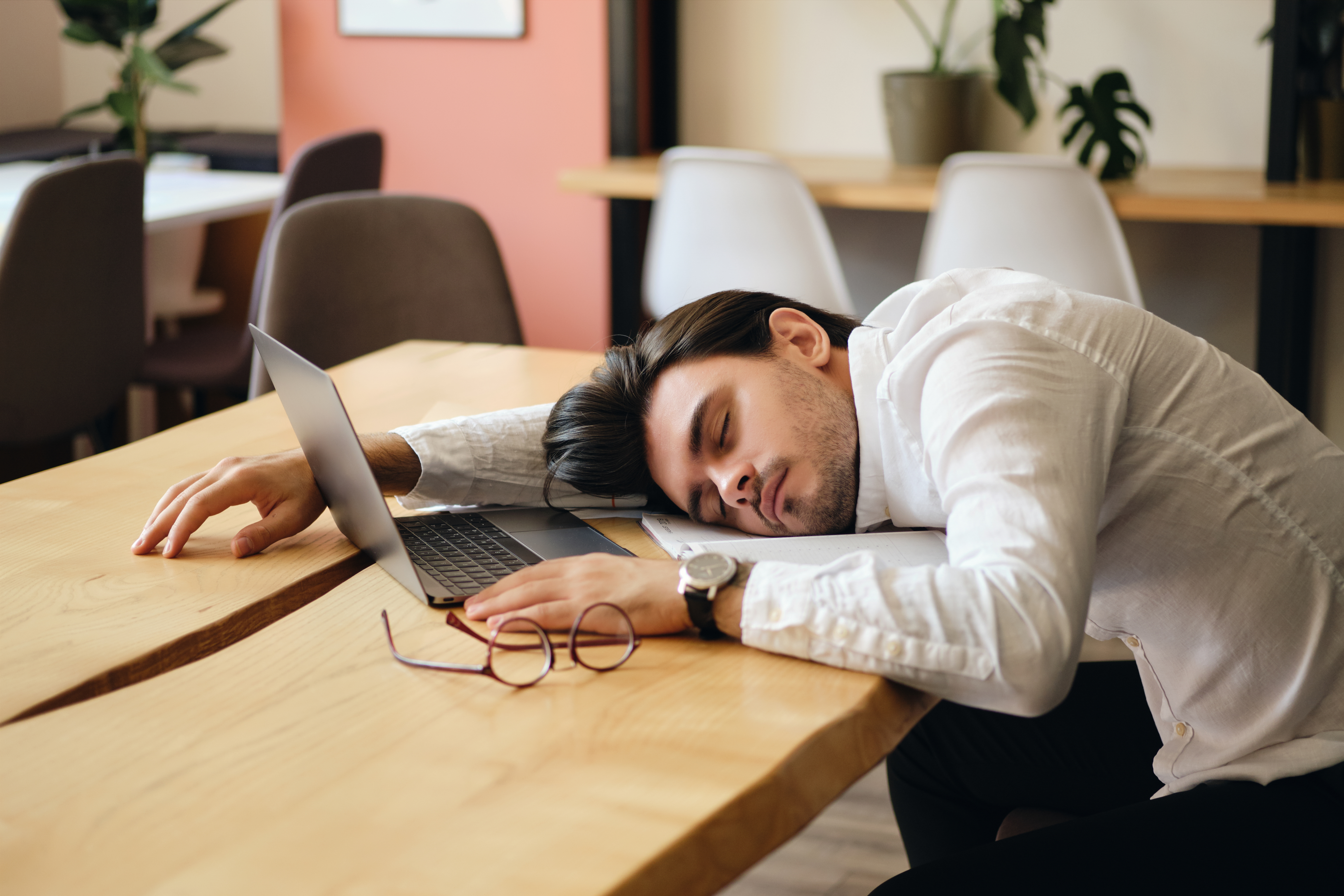 Man asleep at his desk after exhausting meetings